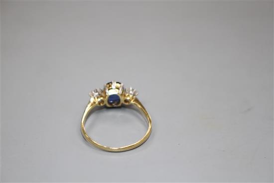 An 18ct and Plat, sapphire and diamond set three stone ring, size O/P, gross weight 2.3 grams.